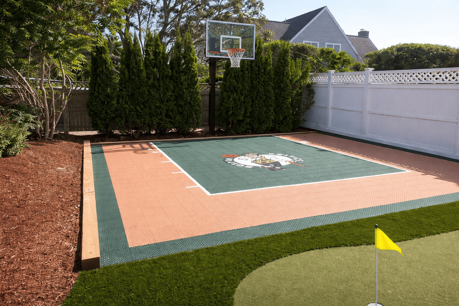 Backyard basketball court with mascot logo
