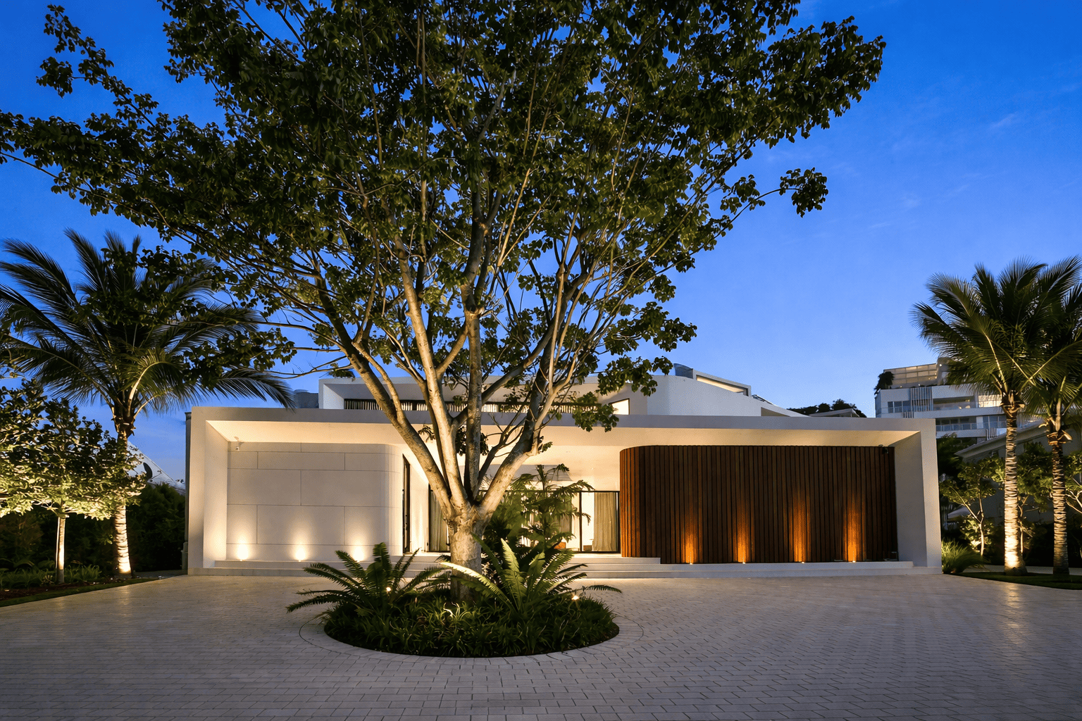 Modern home at twilight with tree